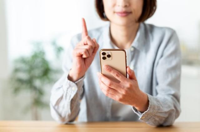 携帯を手にアドバイスを促す女性