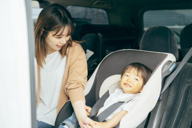 チャイルドシートに座る子どもと保護者